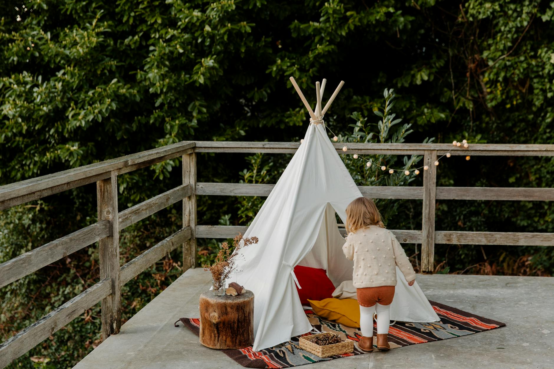 little kid coming in wigwam on terrace